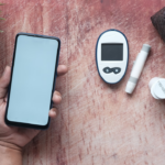 a person holding a smart phone next to an electronic device — Foto por Towfiqu barbhuiya na Unsplash